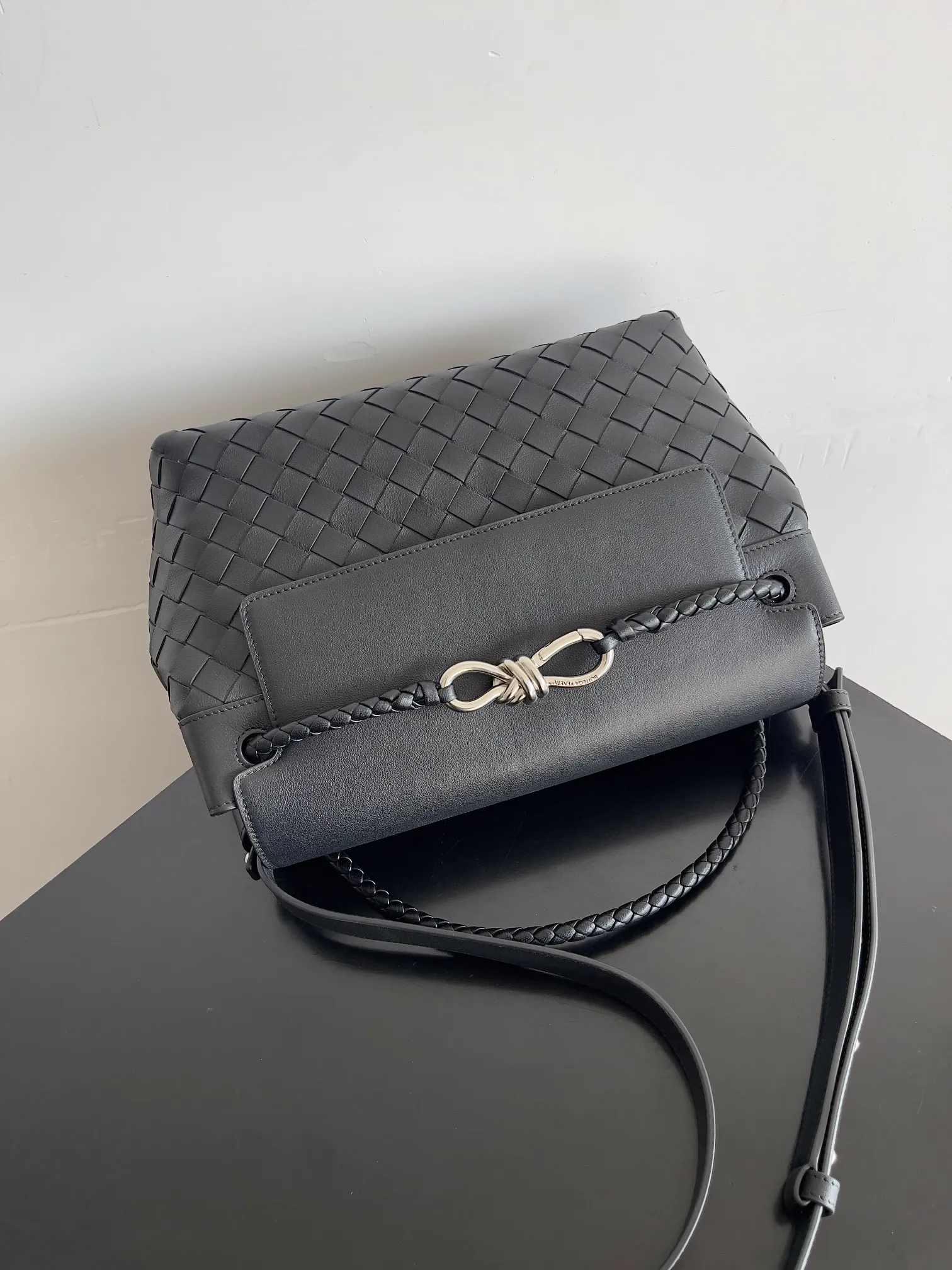 Batch 2460 BOTTEGA VENETA Bottega Veneta's 2025 new product for men ANDIAMO Bottega Veneta's main recommendation is undoubtedly the Andiamo small size. The first new favorite of the 2025 new product is a men's figure buckle bag. It can be seen that the designer has used many small ideas. The detachable crossbody strap is very convenient. It is convenient for elite office workers to reduce the burden on their hands when carrying work logs and office supplies. The interior is divided into two large compartments and a small zippered compartment. Unlike the women's model, the compartments here are not removable. The fixed large single layer also makes it easier to pack lightly when going out to work, and avoids the accumulation of too many small items. Style number: 815781 Size: 29*20*13cm